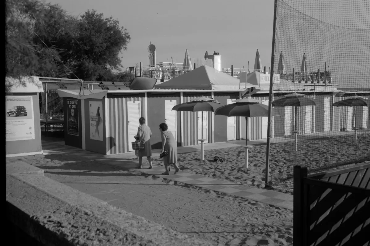 Black and white photo of two elderly women leaving an Italian beach
